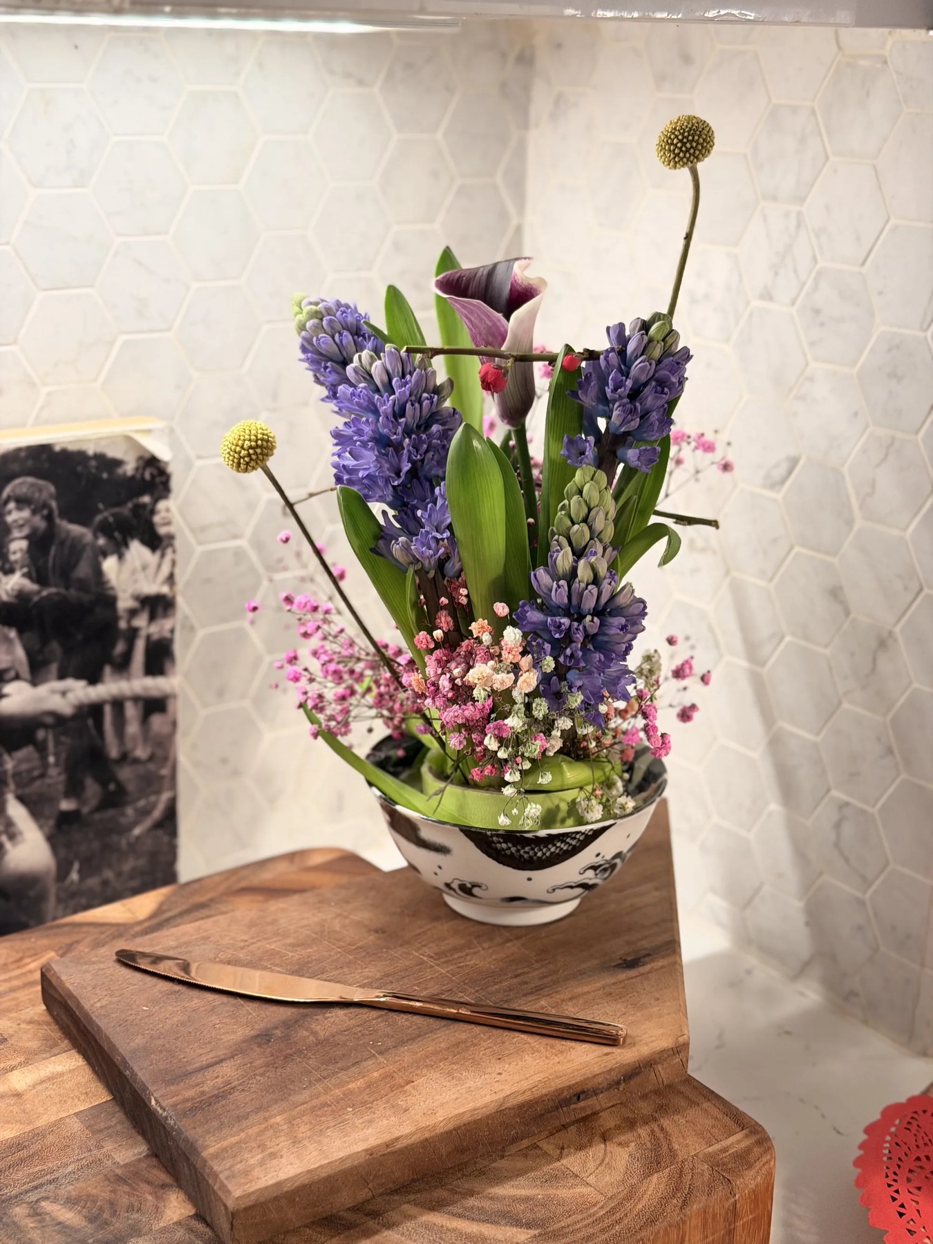 Sculptural floral arrangement in kitchen bowl