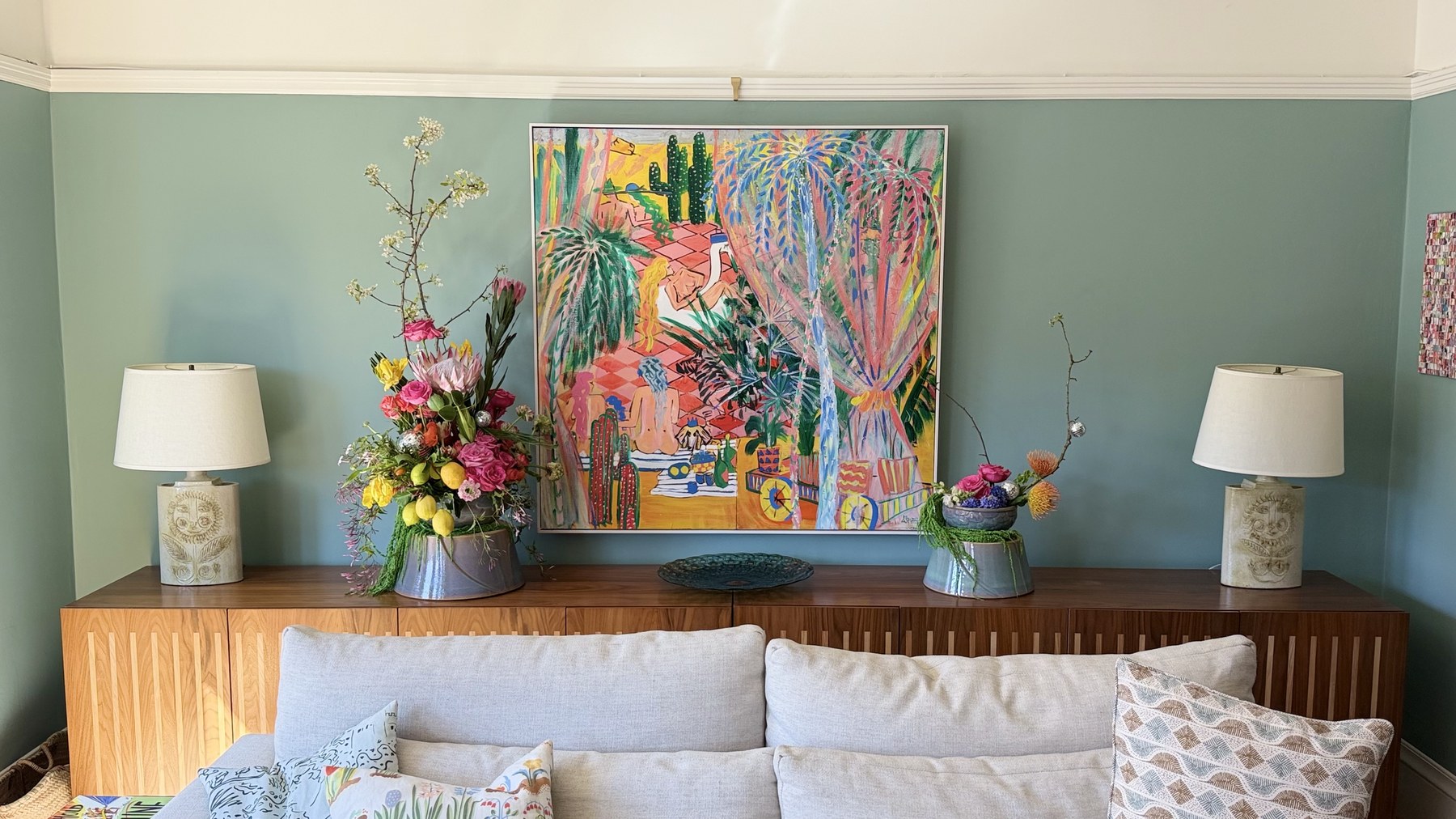 Both Full Moon Summoning arrangements installed on credenza with tropical painting