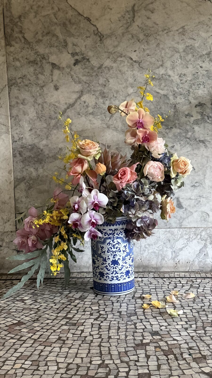 Sculptural seasonal arrangement in a blue-and-white vase