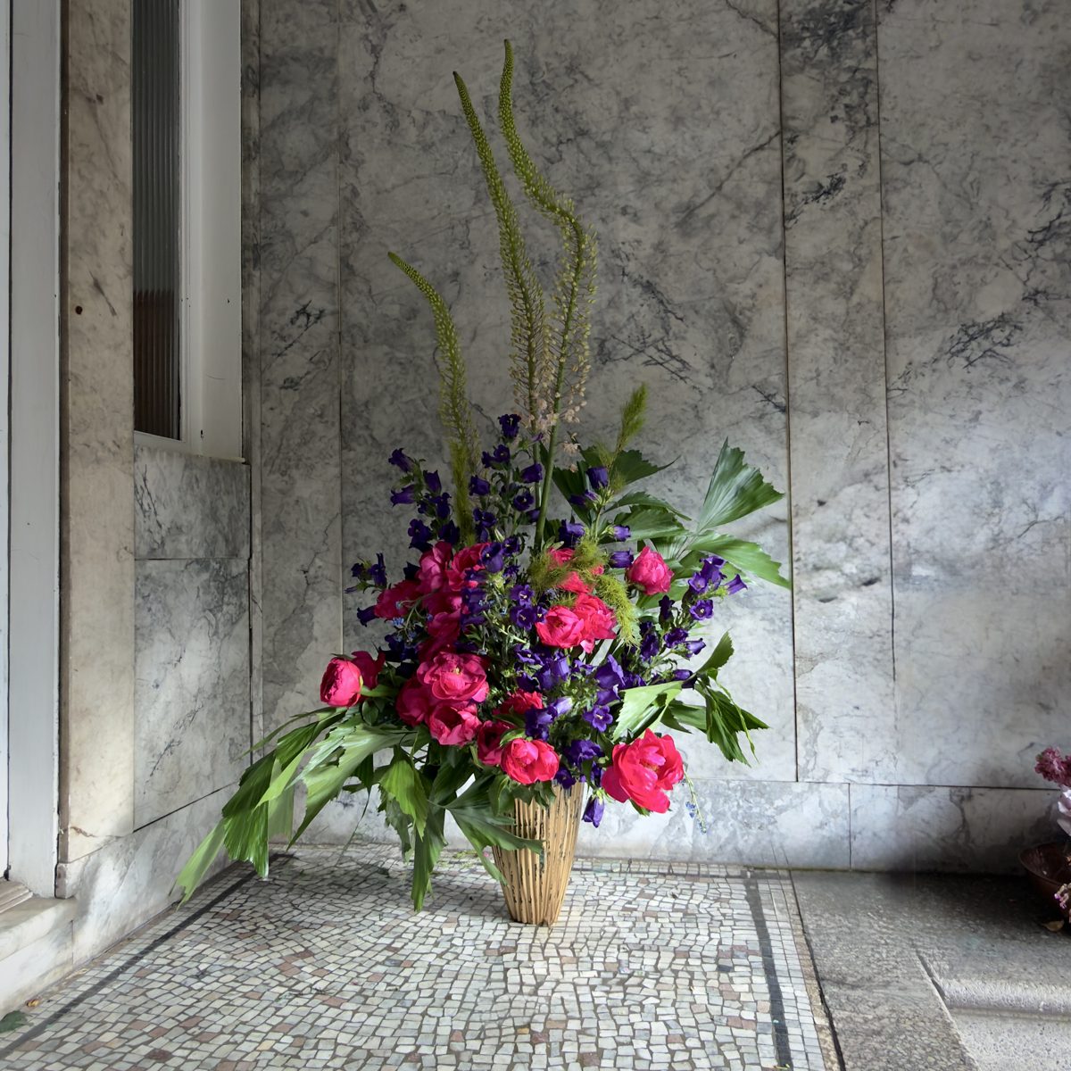 Example of The Coven — towering foxtail lilies and hot pink peonies against marble