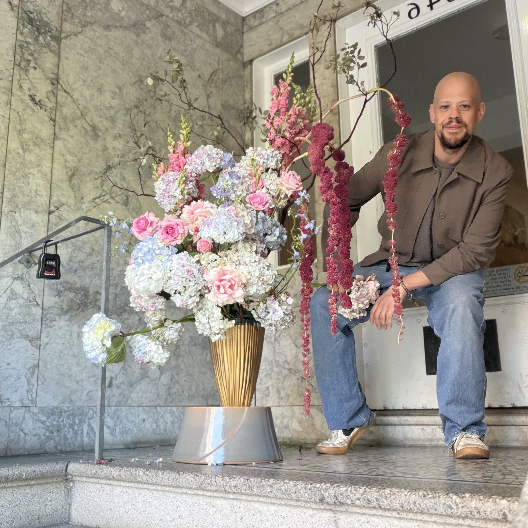 Brandon Joseph photographed on a flight of stone stairs