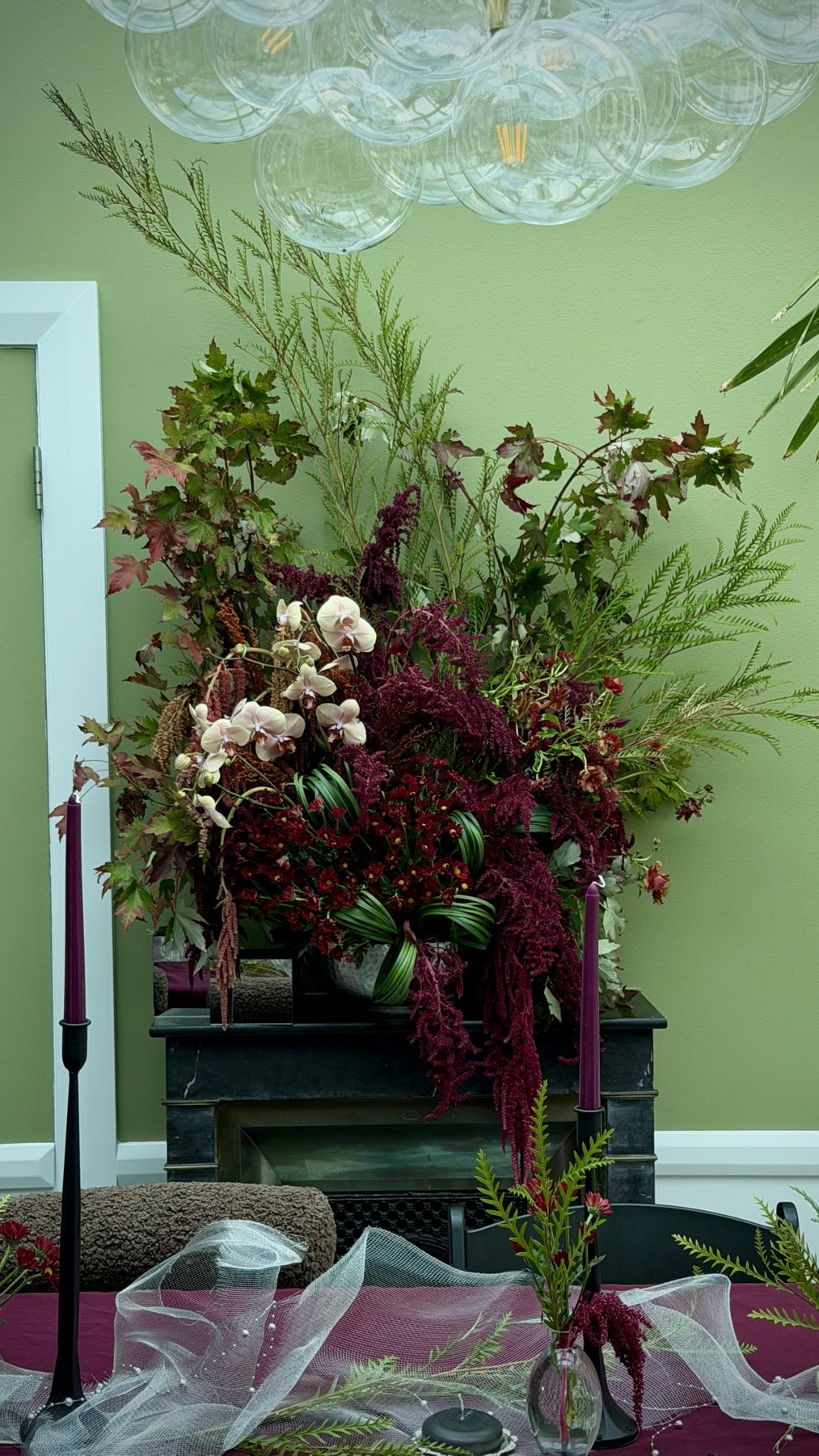An autumn botanical installation at a fireplace in a private Russian Hill residence.