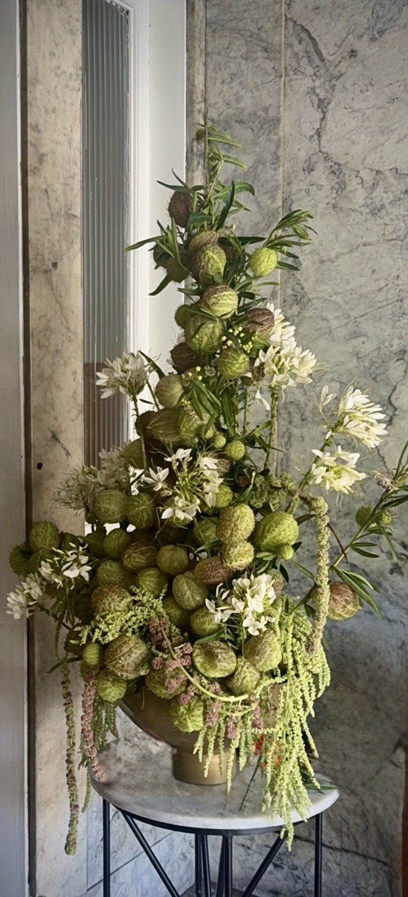 A tower-shaped floral installation for xAI in San Francisco.